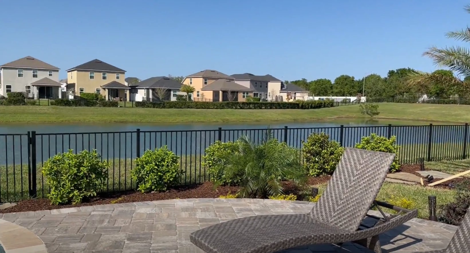 High-end landscape installation showcasing professional design and quality craftsmanship Waterfront property with professional landscaping, outdoor furniture, and scenic views